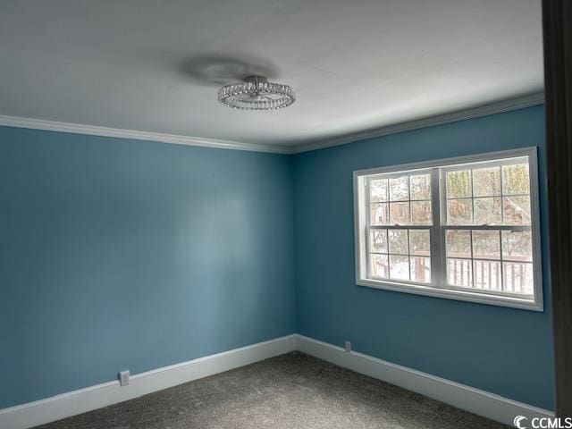 empty room with ornamental molding and carpet