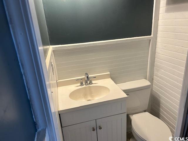 bathroom featuring vanity and toilet