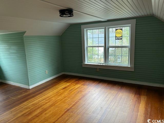 bonus room featuring hardwood / wood-style floors and vaulted ceiling