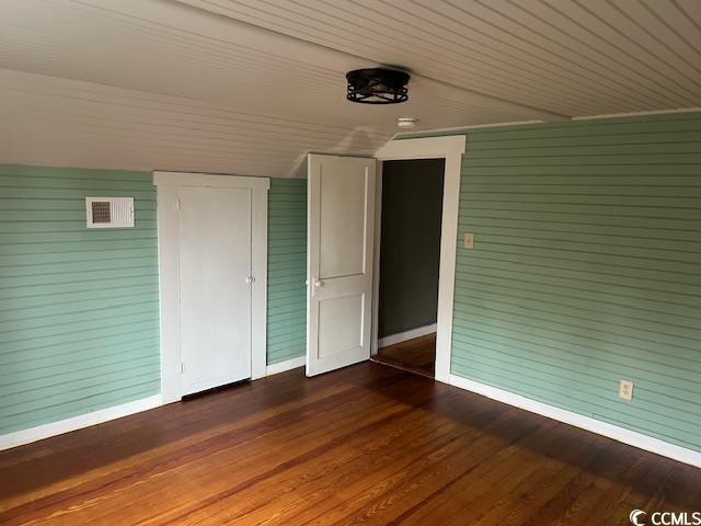 2708 Main St, Loris, SC 29569 - unfurnished bedroom with baseboards and dark wood finished floors