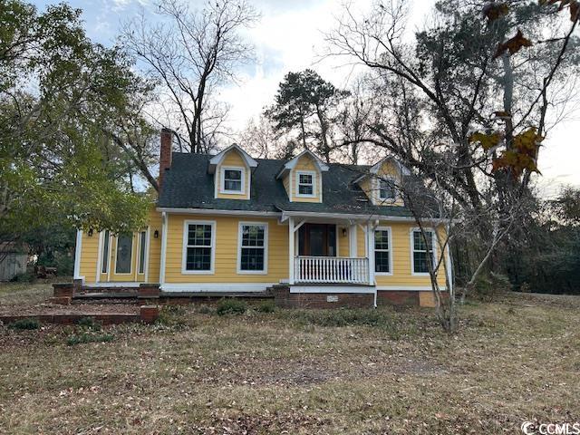 2708 Main St, Loris, SC 29569 - cape cod house featuring covered porch and a chimney