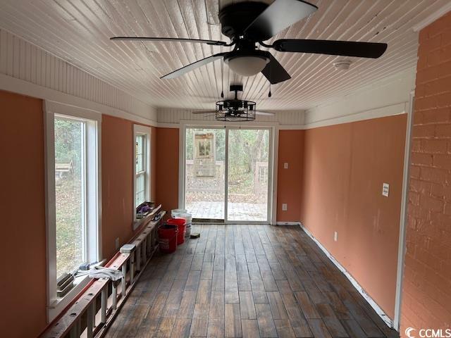 unfurnished sunroom with ceiling fan