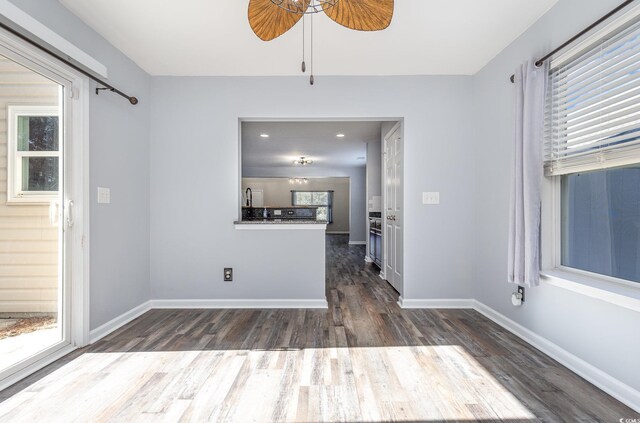 interior space with ceiling fan and dark wood-type flooring