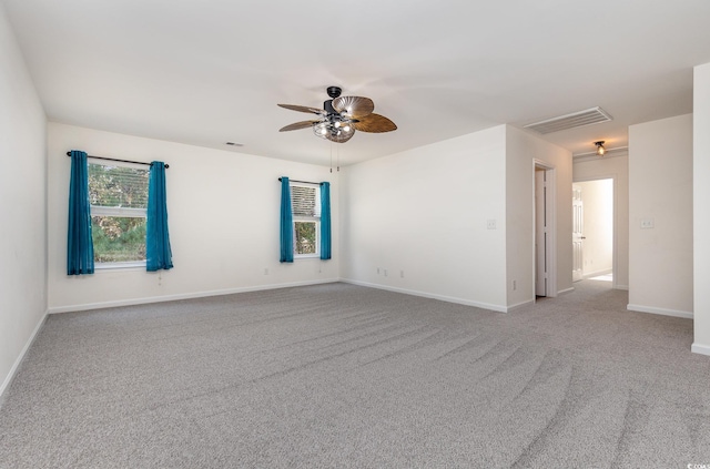 spare room featuring light carpet and ceiling fan