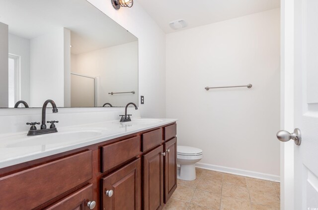 bathroom with vanity, toilet, and a shower with shower door