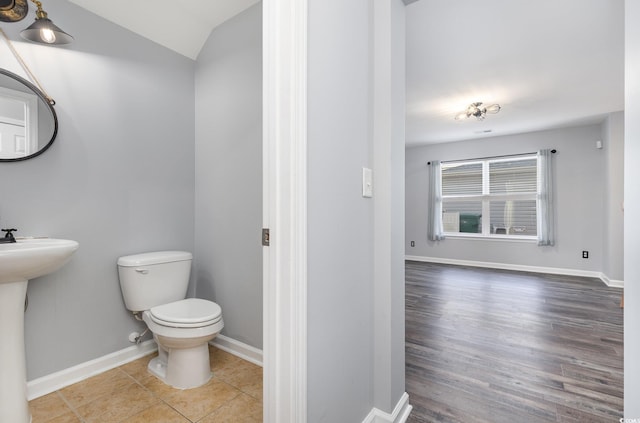 bathroom with hardwood / wood-style floors, toilet, and sink