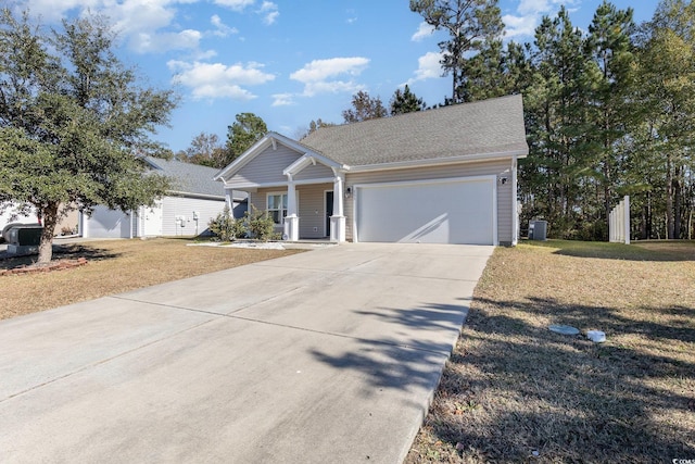 view of front of property featuring central AC, a front yard, and a garage