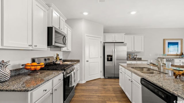 kitchen with sink, white cabinets, stainless steel appliances, and dark hardwood / wood-style floors