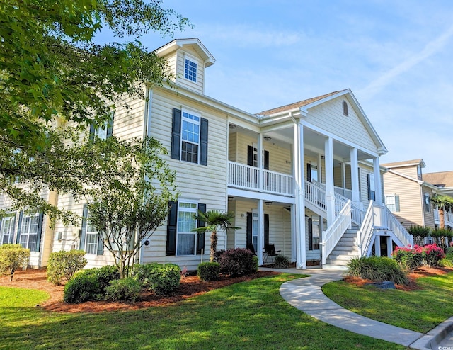 view of front of home with a front yard and covered porch