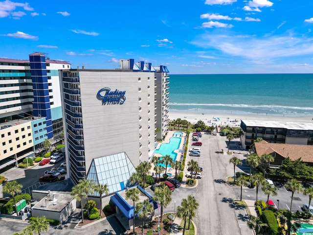 drone / aerial view with a water view and a beach view