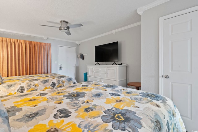 bedroom featuring ceiling fan, a textured ceiling, and ornamental molding