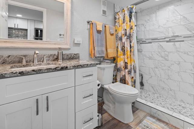 bathroom featuring vanity, toilet, a shower with shower curtain, and hardwood / wood-style flooring