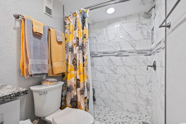 bathroom with toilet and walk in shower