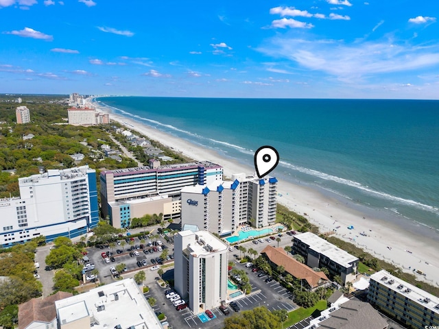 birds eye view of property with a beach view and a water view