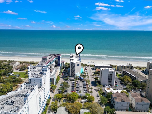 birds eye view of property featuring a water view and a beach view