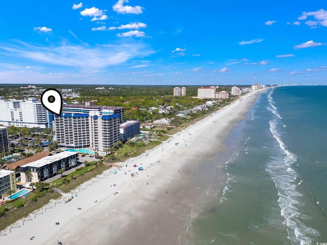 birds eye view of property featuring a water view and a beach view