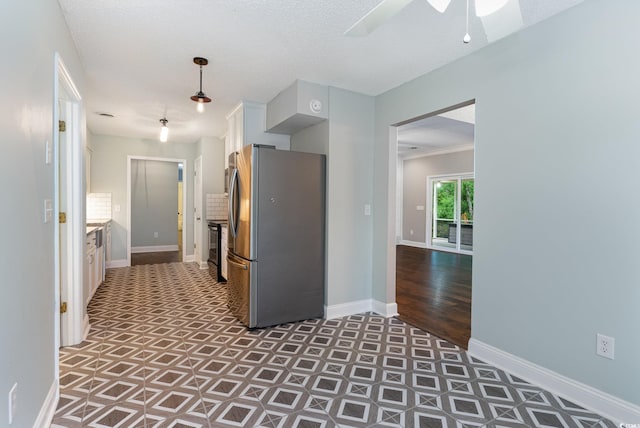 kitchen featuring white cabinetry, ceiling fan, dark wood-type flooring, stainless steel appliances, and a textured ceiling