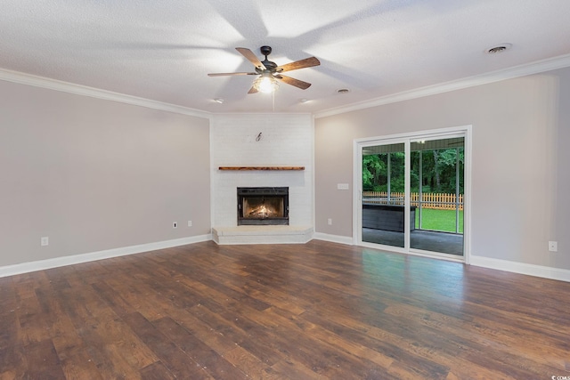 unfurnished living room with ornamental molding, a textured ceiling, ceiling fan, a fireplace, and dark hardwood / wood-style floors