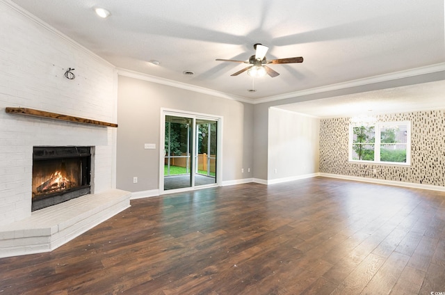 unfurnished living room featuring a textured ceiling, ceiling fan, crown molding, a fireplace, and dark hardwood / wood-style floors