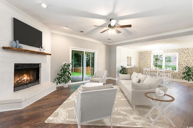 living room featuring ceiling fan, dark hardwood / wood-style flooring, ornamental molding, and a fireplace