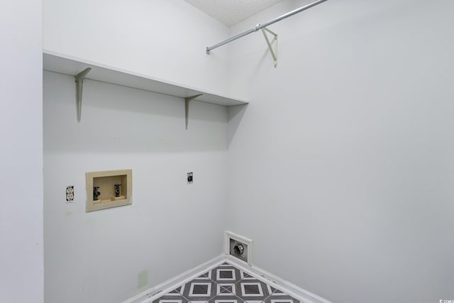 laundry room with hookup for a washing machine, a textured ceiling, and hookup for an electric dryer