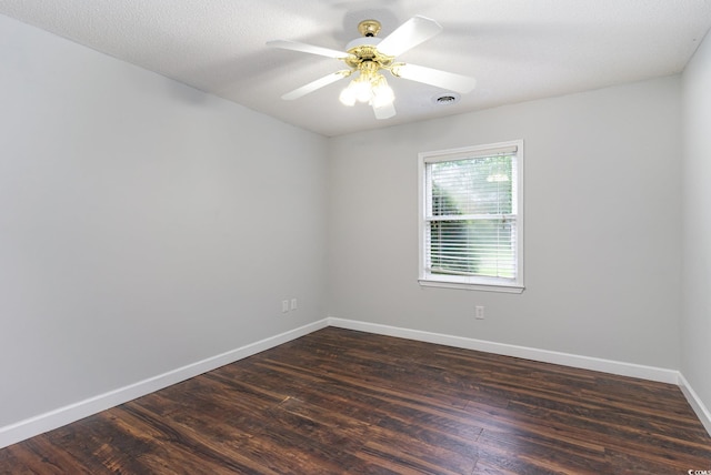 empty room with a textured ceiling, ceiling fan, and dark wood-type flooring