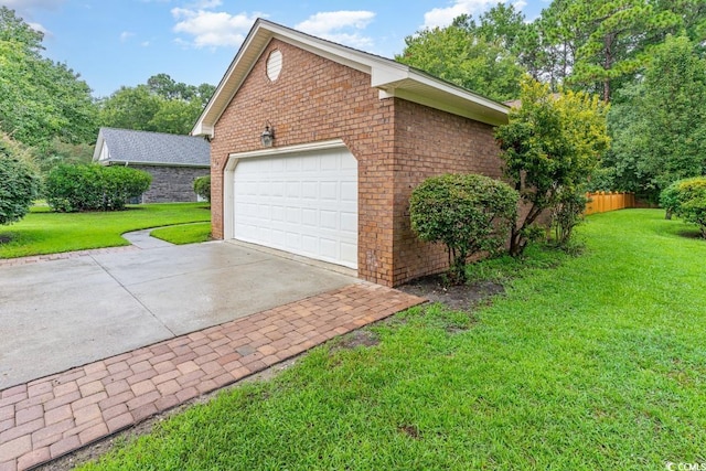 view of home's exterior featuring a garage and a yard