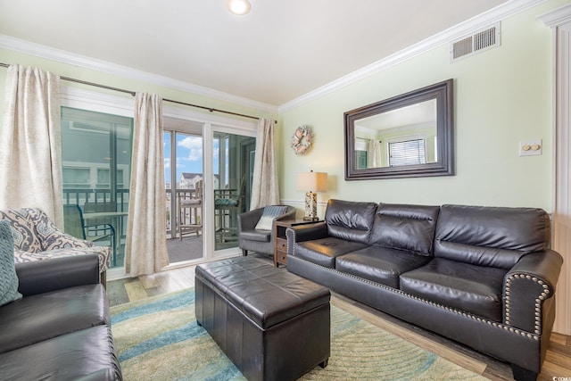 living room featuring wood-type flooring and crown molding