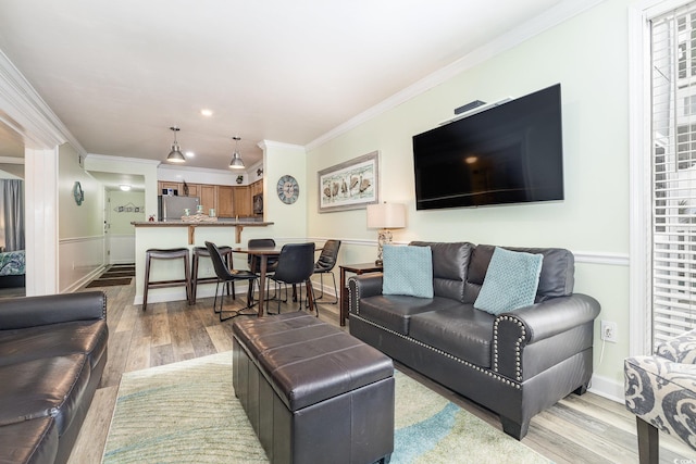 living room featuring light hardwood / wood-style flooring and ornamental molding