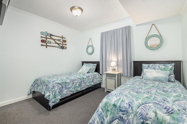 bedroom featuring a textured ceiling, dark colored carpet, and ornamental molding