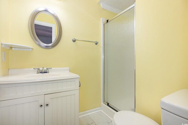 bathroom featuring toilet, a shower with door, and vanity