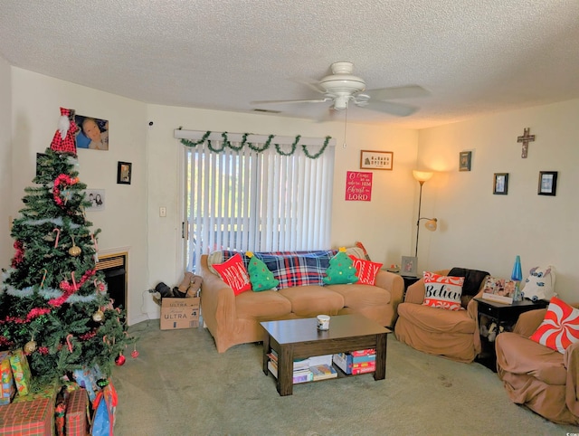 living area with a ceiling fan, carpet, visible vents, and a textured ceiling