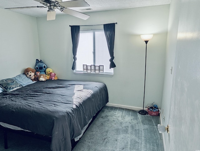 carpeted bedroom featuring a textured ceiling and ceiling fan