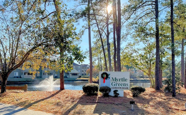 community / neighborhood sign with a water view