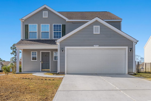 view of front property featuring a front yard and a garage