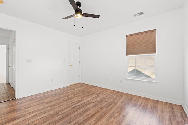 unfurnished room with ceiling fan and light wood-type flooring