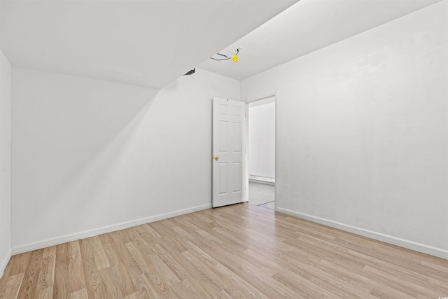 bonus room featuring light wood-type flooring and baseboard heating