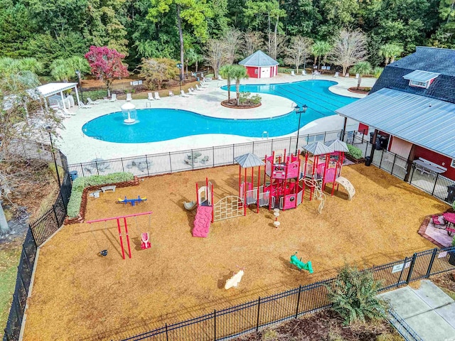 view of swimming pool featuring a playground