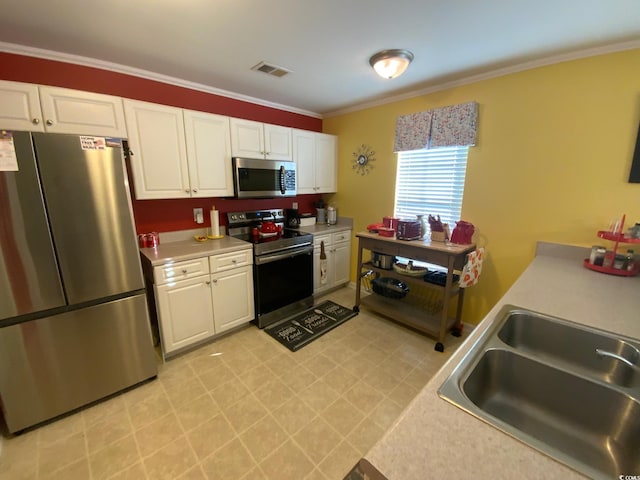 kitchen with sink, white cabinetry, stainless steel appliances, and ornamental molding