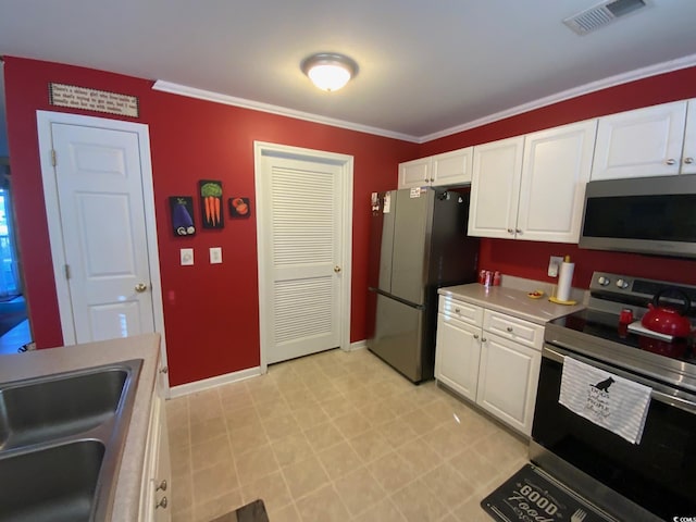 kitchen featuring crown molding, sink, white cabinets, and appliances with stainless steel finishes