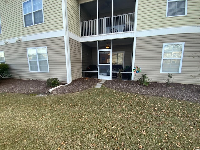 doorway to property with a yard