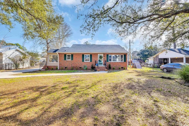 view of front facade with crawl space, brick siding, fence, and a front lawn