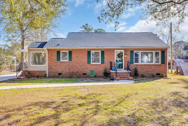 view of front of house featuring crawl space, a shingled roof, a front lawn, and brick siding