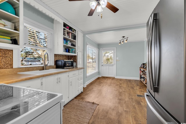 kitchen featuring white cabinets, open shelves, light countertops, and freestanding refrigerator