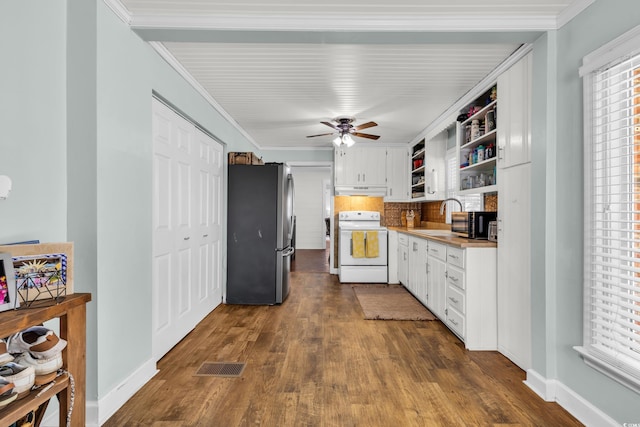 kitchen with electric stove, open shelves, light countertops, freestanding refrigerator, and white cabinets