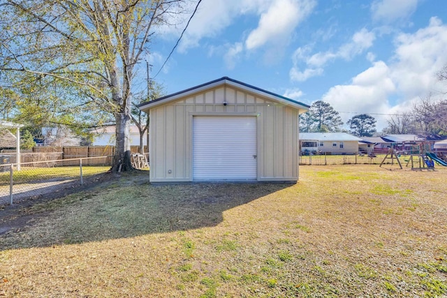 garage with fence and a storage unit