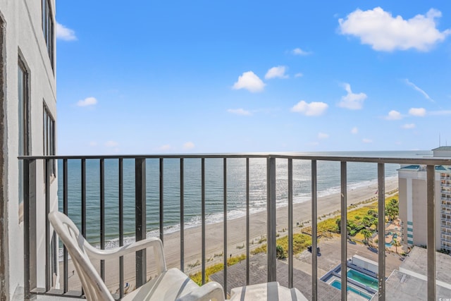 balcony with a beach view and a water view