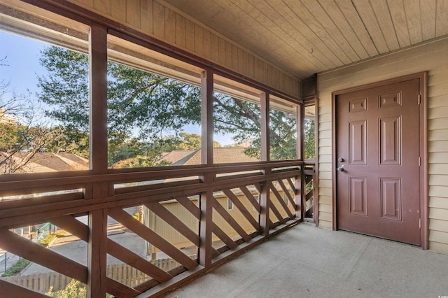 unfurnished sunroom with a healthy amount of sunlight and wood ceiling