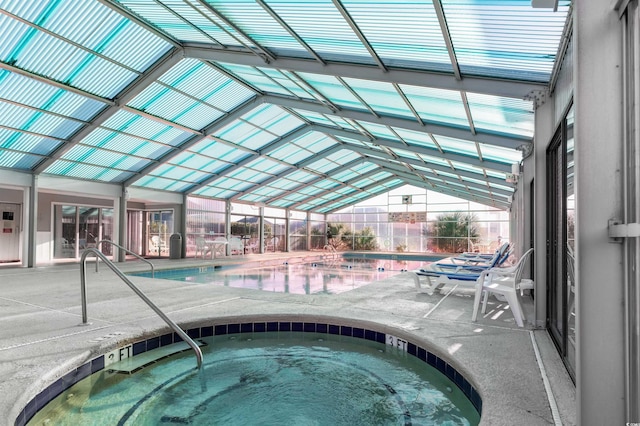 view of pool featuring an indoor hot tub, a patio, and a lanai