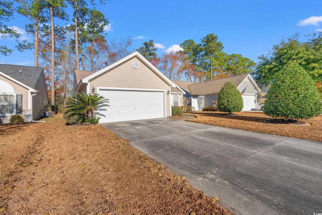 view of front of home featuring a garage and central AC